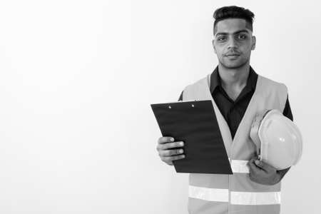Young Indian man construction worker against white backgroundの写真素材