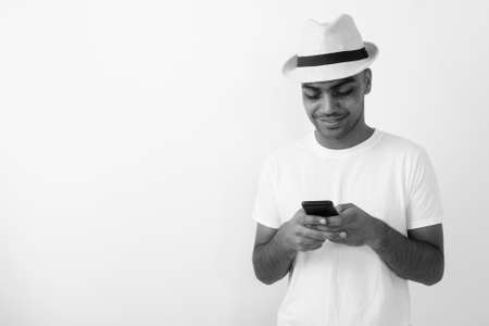 Young Indian tourist man wearing hat against white backgroundの写真素材