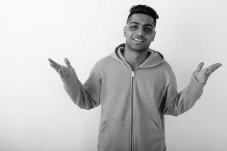 Young Indian man wearing hoodie against white backgroundの写真素材