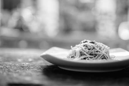 Spaghetti With Pesto Sauce Against Wooden Tableの写真素材