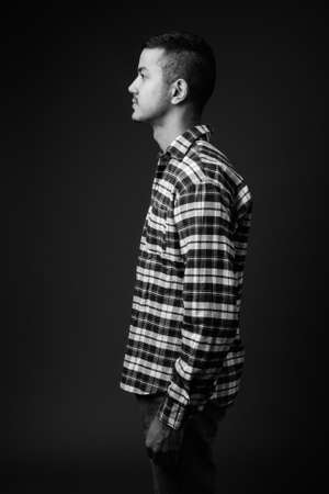 Young multi ethnic Asian man against gray backgroundの写真素材