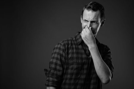 Studio shot of hipster man against gray background