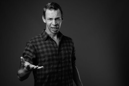 Studio shot of hipster man against gray background