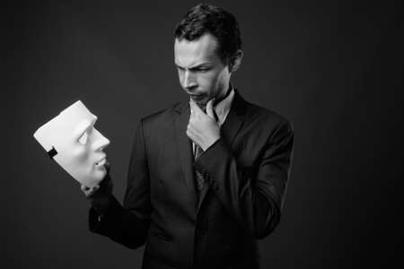 Studio shot of businessman against gray backgroundの写真素材