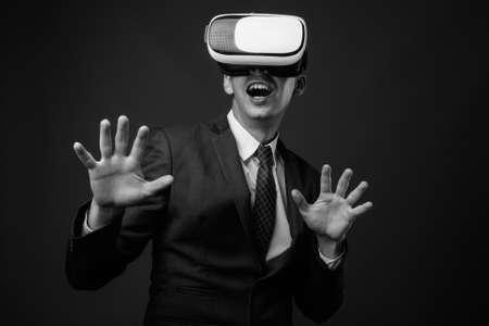 Studio shot of businessman against gray backgroundの写真素材