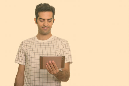 Portrait of young Persian man using digital tablet