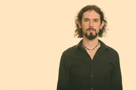 Portrait of handsome bearded businessman with curly hair