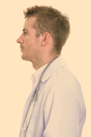 Profile view of handsome man doctor with blond hairの写真素材