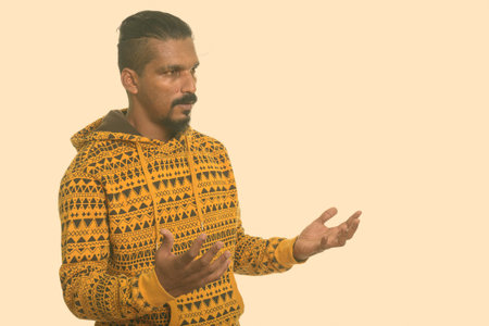 Young Indian man with both arms raised