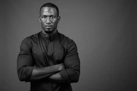Handsome African businessman against brown backgroundの写真素材