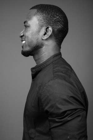 Handsome African businessman against brown backgroundの写真素材