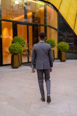 Full length rear view shot of businessman walkingの写真素材