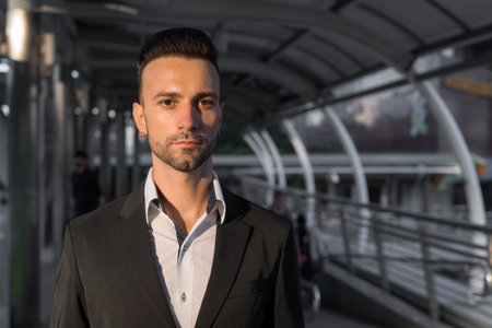 Portrait of handsome young businessman outdoors in cityの写真素材
