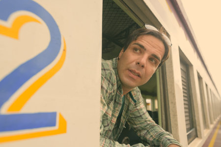 Handsome Persian tourist man at the railway station in Bangkok, Thailand