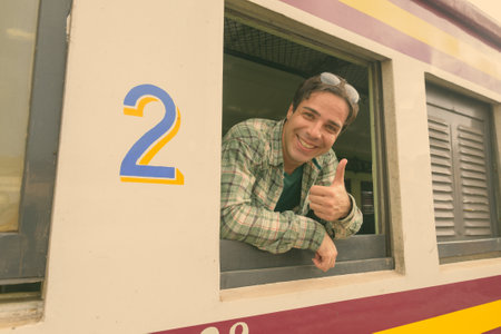 Handsome Persian tourist man at the railway station in Bangkok, Thailandの写真素材