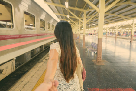 Young beautiful Asian tourist woman at the railway station in Bangkok, Thailandの写真素材