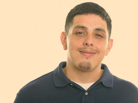 Close up of young Hispanic man smiling and looking at camera