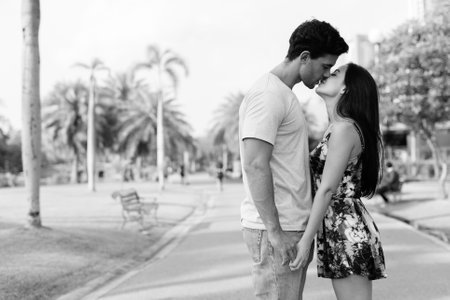 Young Hispanic couple relaxing in the park togetherの写真素材
