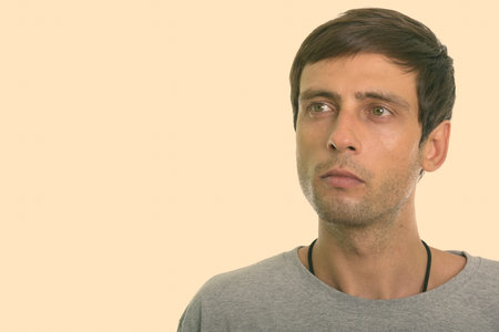 Close up of young handsome man thinking and looking up