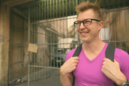 Young handsome tourist man exploring around the city of Bangkok, Thailandの写真素材