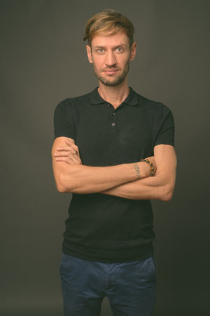 Studio shot of blond bearded man against gray backgroundの写真素材