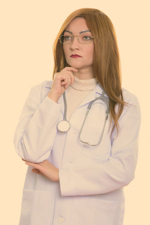 Studio shot of woman doctor thinkingの写真素材