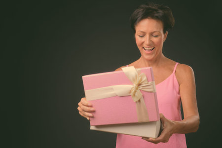Mature beautiful woman with short hair against black background