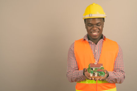 Young African man construction worker against white backgroundの写真素材