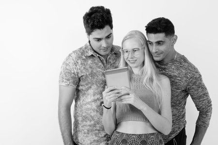 Three multi-ethnic friends together against white background