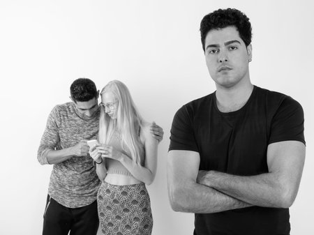 Three multi-ethnic friends together against white background