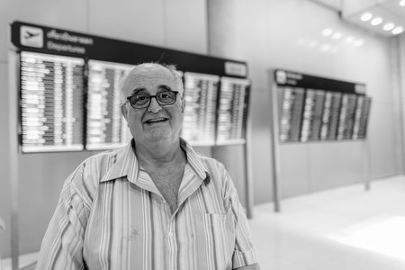 Overweight senior tourist man lounging around the airport of Bangkok, Thailand