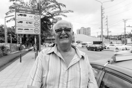 Overweight senior tourist man exploring around the city of Bangkok, Thailandの写真素材