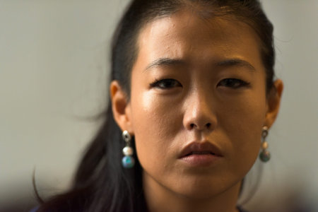 Close-up portrait of beautiful rebel Asian woman face outdoors