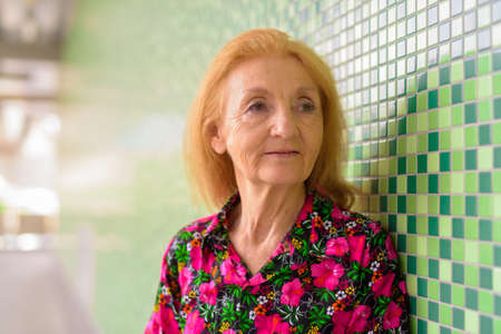 Portrait of a senior woman outdoors during summer thinkingの写真素材