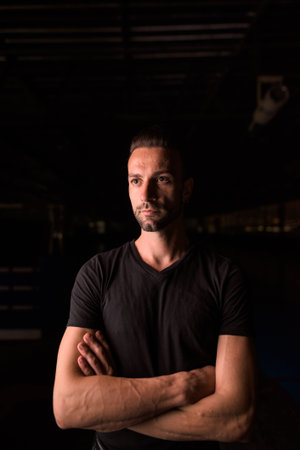 Portrait of handsome man thinking at night in parking lot building
