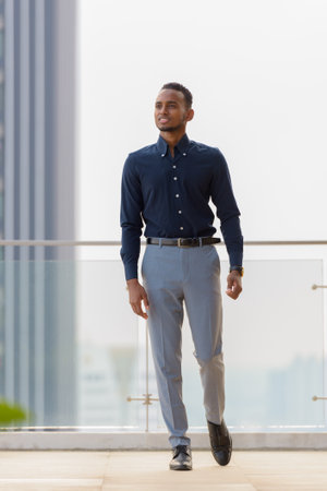 Portrait of handsome African businessman outdoors at rooftop in Bangkok, Thailandの写真素材