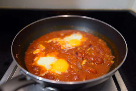 Shakshouka spicy tomato stew with chicken eggs traditional vegetarian dish horizontal shotの写真素材