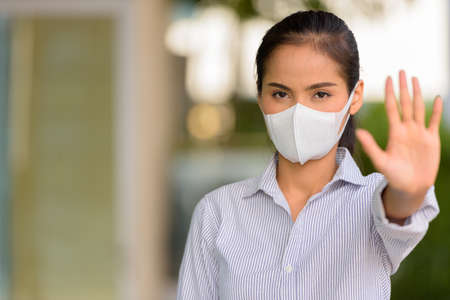 Asian woman wearing face mask to protect from coronavirus Covid-19 horizontal shotの写真素材