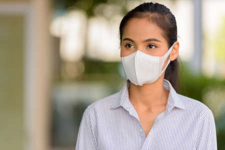Asian woman wearing face mask to protect from coronavirus Covid-19 horizontal shotの写真素材