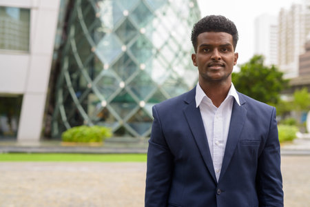 Portrait of African businessman outdoors in city horizontal shot