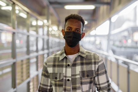 Portrait of African black man outdoors in city during summer horizontal shot