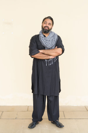 Portrait of handsome Indian man against plain backgroundの写真素材