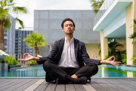 Portrait of man Asian businessman wearing suit and relaxing outdoorsの写真素材