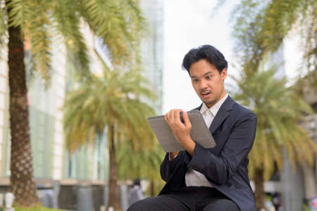 Portrait of Asian businessman outdoors in Bangkok Thailandの写真素材