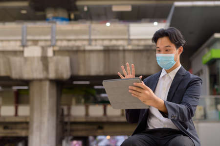 Portrait of Asian businessman outdoors in Bangkok Thailandの写真素材
