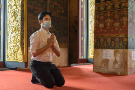 Portrait of Asian businessman in buddhist templeの写真素材