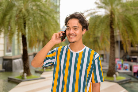 Portrait of handsome young man wearing colorful shirt outdoors during summer