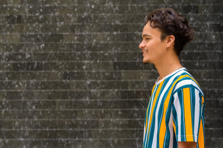 Portrait of handsome young man wearing colorful shirt outdoors during summerの写真素材