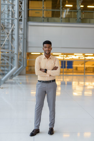 Full length portrait of young handsome African businessman in city vertical shot