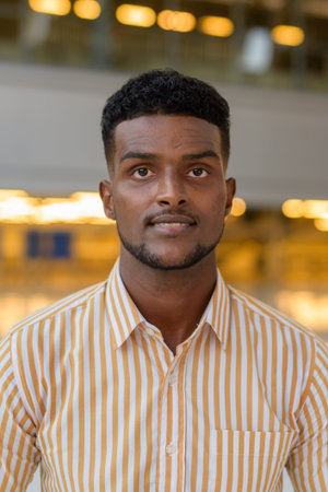 Portrait of young handsome African businessman wearing stylish clothes